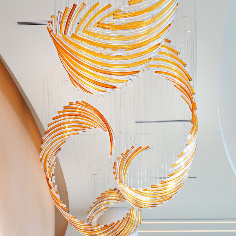 Modern hotel corridor decorated with long rotating glass chandelier