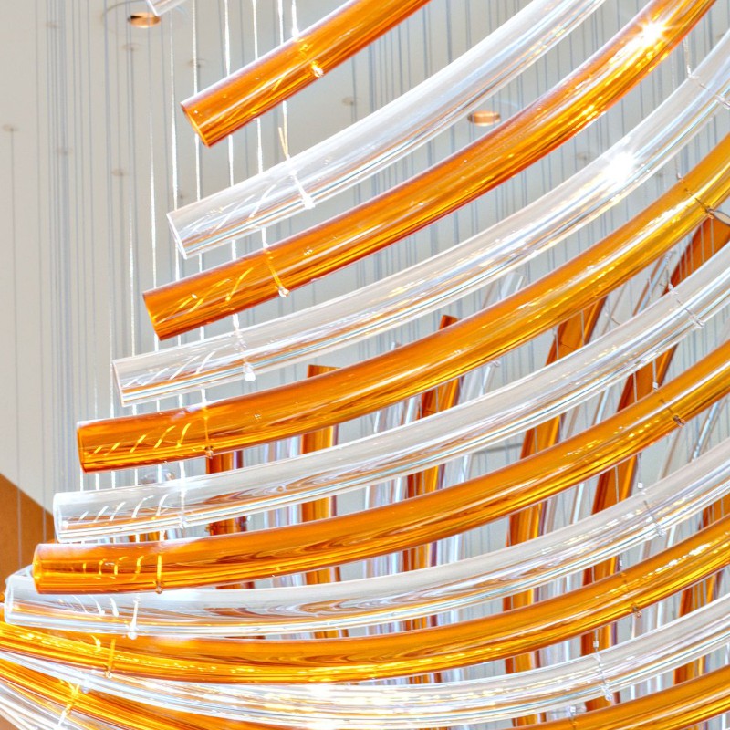 Modern hotel corridor decorated with long rotating glass chandelier
